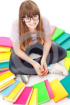 Child with lot of books siting on floor