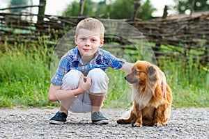 Child lovingly embraces his pet dog. Best friends. Outdoor