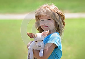 Child lovingly embraces his pet dog. Close up, copy space. Best friends kid and puppy rest and have fun on vacation