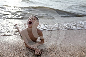 Child lying on beach of Azov sea photo