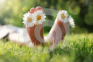 Child lying in meadow relaxing in summer sunshine