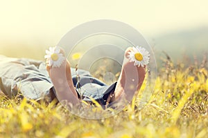 Child lying in meadow relaxing in summer sunshine