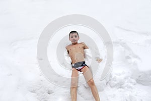 Child lying in snow