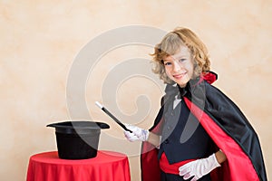 Child magician holding magic wand