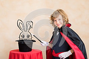Child magician holding magic wand