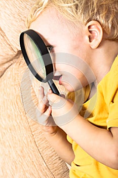 Child with magnifying glass