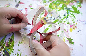 Child making a buttlerfly with recycled materials and EVA foam photo