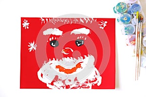 Child making a greeting card. Craft for children. Nice greeting card with happy Santa. Top view