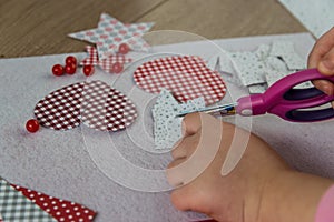Child making greeting card with paper hearts