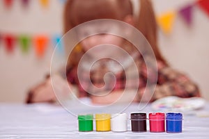 Child making homemade greeting card. Little girl paints heart on homemade greeting card as gift for Mother Day.