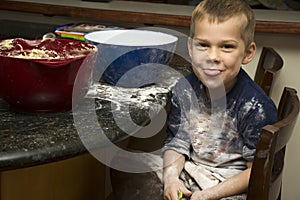 Child making a mess baking with mom