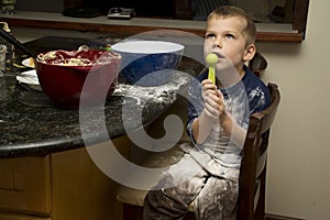 Child making a mess baking with mom