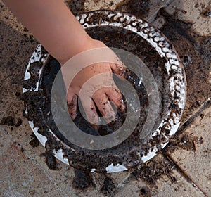 Child making a mud pie