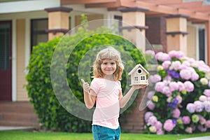 Child making a new dream home. Housing a young family. Family housing, home mortgage, real estate.