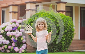 Child making a new dream home. Housing a young family. Family housing, home mortgage, real estate.