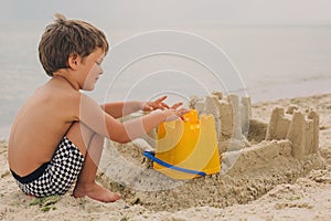 Child making sand castles at the beach