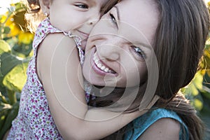 Child and mama on sunflowers