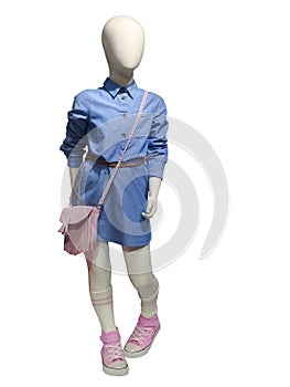 Child mannequin wearing blue dress.