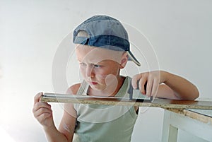 Child measuring wooden plank