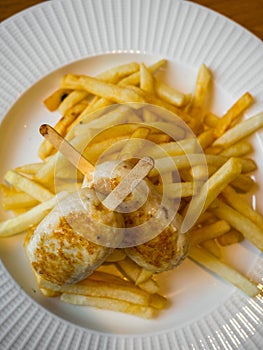 Child menu - french fries and chicken cutlets in the form of popsicle