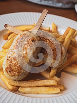 Child menu - french fries and chicken cutlets in the form of popsicle