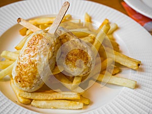 Child menu - french fries and chicken cutlets in the form of popsicle