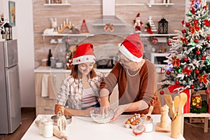 Child mixing cookies ingredients in bowl making traditional homemade dough