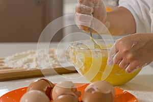 Child mixing ingredients in a mixing bowl