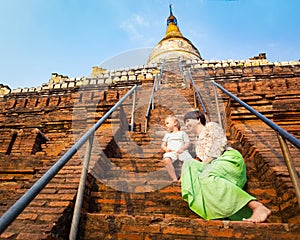 Child and Mom climbing on Shwesandaw pagoda in Bagan. Myanmar