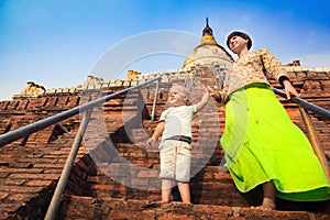 Child and Mom climbing on Shwesandaw pagoda in Bagan. Myanmar