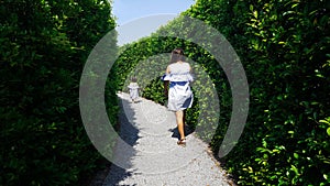 Child and mom escape maze green plant wall