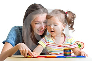 Child and mom playing together with toys