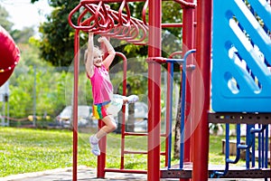 Child on monkey bars. Kid at school playground