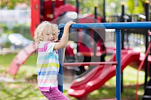 Child on monkey bars. Kid at school playground