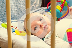 Child 3 months old lies alone in bed