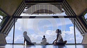 Child and mother doing yoga exercise at morning