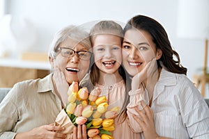 child, mother and granny with flowers