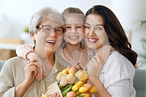 child, mother and granny with flowers