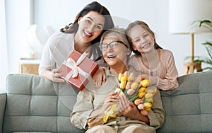 child, mother and granny with flowers