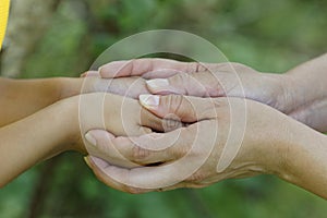 Child and mother holding hands