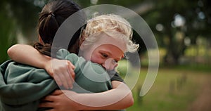 Child, mother and hug at a park outdoor in nature for happiness, adventure or fun play. A woman and girl kid embrace in