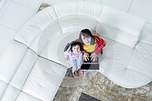 Child and mother with laptop smiling