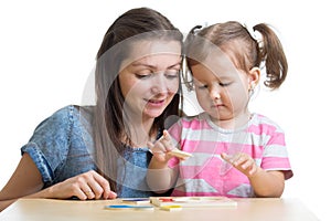 Child and mother playing together with puzzle toy