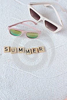 Child and mother sunglasses on the sand, family beach mood