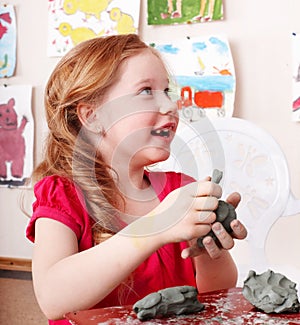 Child mould from clay in play room.