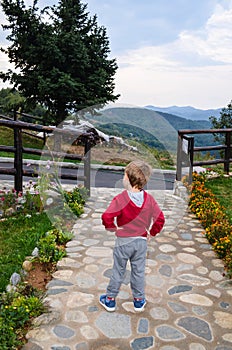 Child in a Mountain resort in a rainy day