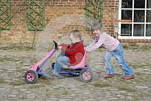 Child moves pedal car