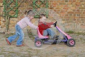 Child moves pedal car