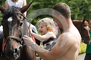 Child with muscular macho smile to animal photo