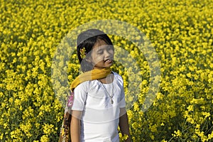 An Indian child and mustard flower in India